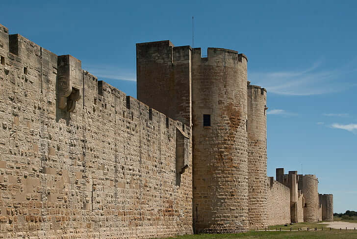 A large brown castle under a blue sky.