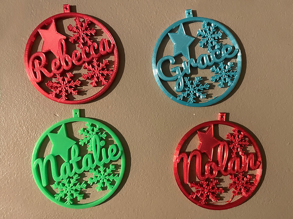 Four ornaments with the names Rebecca, Grace, Natalie, and nolan. 